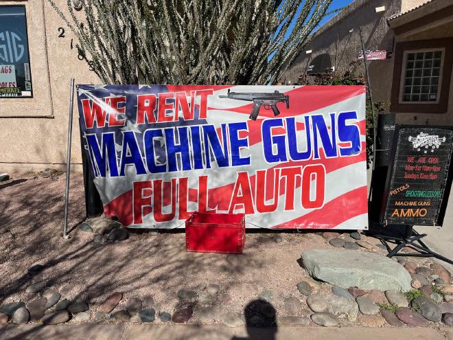 Machine guns for rent sign