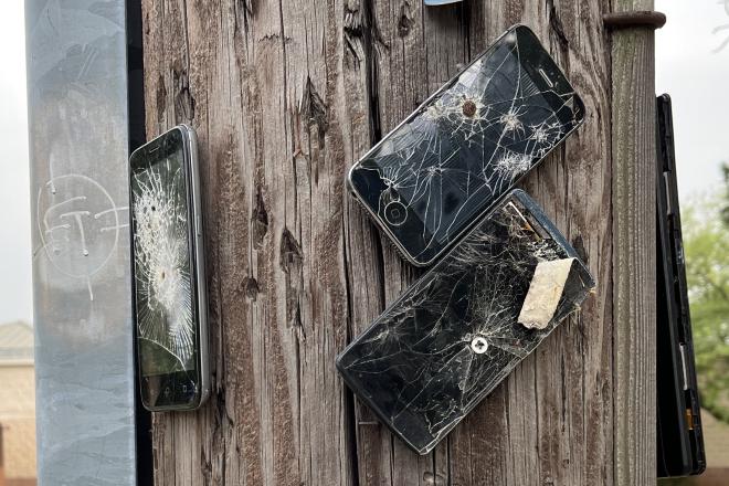 Phones nailed to a post.