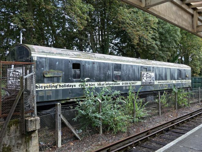 A run-down old railway carriage yet it has URLs on